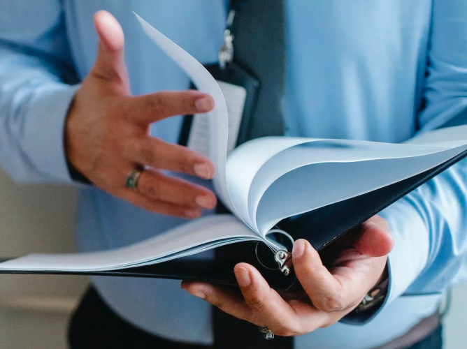 Business man holding a book
